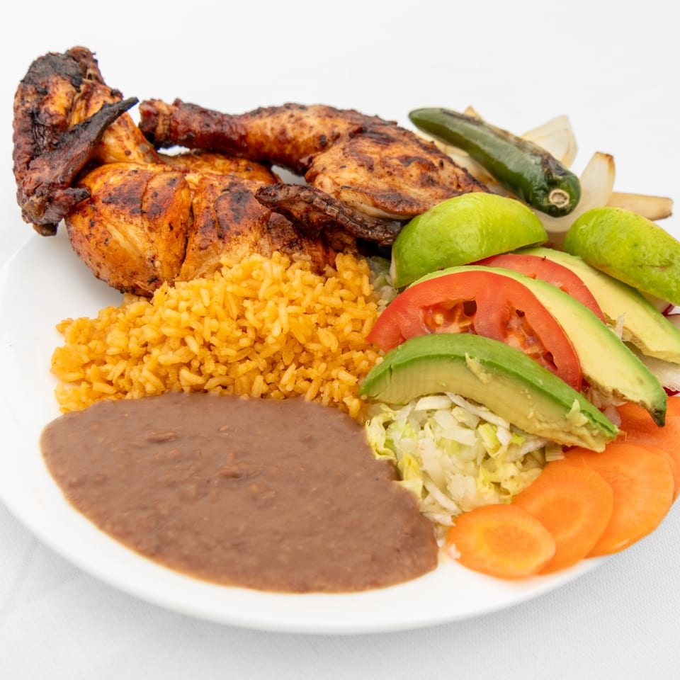 Grilled chicken with rice, refried beans, avocado, tomato, lettuce, carrots, lime, and jalapeño.